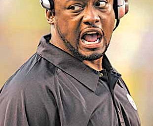 Pittsburgh Steelers head coach Mike Tomlin congratulates players on his special teams after a first quarter punt return against the Green Bay Packers during pre-season football action in Pittsburgh, in this Aug. 11, 2007 file photo.