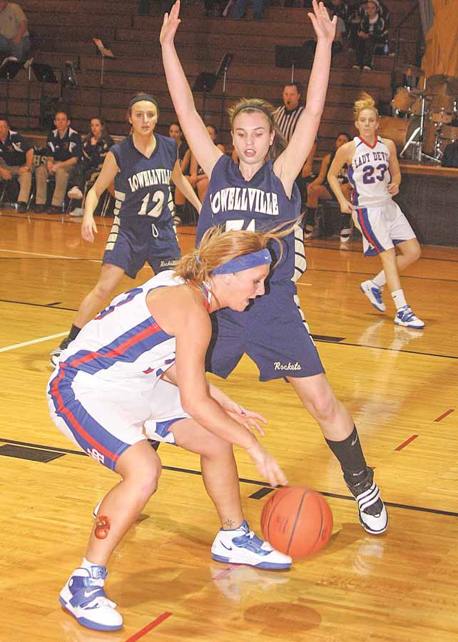 Lowellville’s Rachel Durbin (31) defends Western Reserve’s Tori Korda (33) during a basketball game Thursday in Berlin Center. The Rockets needed overtime to defeat the Blue Devils, 65-59.