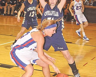 Lowellville’s Rachel Durbin (31) defends Western Reserve’s Tori Korda (33) during a basketball game Thursday in Berlin Center. The Rockets needed overtime to defeat the Blue Devils, 65-59.