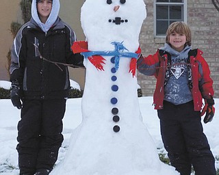 Ivan and Alec Bosnjak of Boardman show off one well-dressed snowman. Photo submitted by their parents, Andrea and Ivan Bosnjak.