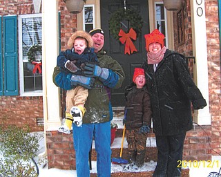 Matt, Meg, Vaughn and Riley Manning of Nashville, Tenn., hang out on their porch during one of many snowfalls this year. Photo sent in by proud grandparents Phyllis and Don Manning of Canfield.