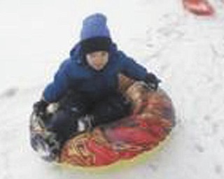 Timmy, 4, of Poland, enjoys playing on a new sled. Photo submitted by Gary Kerr.