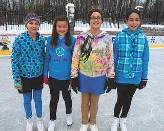 Alesha, Bethany, Olivia and Allison, all of McDonald, enjoy an afternoon of skating at the ice rink built by Rick and Laura Glass on their property in McDonald.