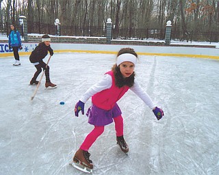 Maria Constantino of McDonald shows off her skating skills during a recent outing to the ice rink built by Rick and Laura Glass on their property in McDonald.