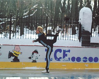 Laura Glass glides along the ice rink she and her husband, Rick, built on their property in McDonald in 2005.