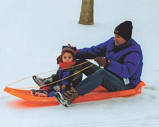While visiting for Christmas, 3 1/2-year-old Oscar Wolf Calipari and his dad, Matthew, found perfect sledding conditions in the backyard at the home of his grandparents, Brian and Kathy Wolf of Liberty.