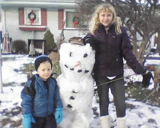 Timmy, 4, and Kayla, 14, both of Poland, proudly show off their snowman. Photo sent in by Gary Kerr.