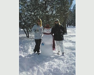 On New Year's Day 2011, Cheri Fisher of Phoenix, Ariz., and Shanna Bradley of Queen Creek, Ariz., built this snowman in the mountains of Happy Jack, Ariz., just a two-hour drive from sunny Phoenix. Photo sent in by Cheri's mom, Peg Sigle of Boardman.
