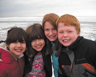 Cousins Erin and Emily Jackson of Boardman and Andrea and Anthony Zuccaro of Kingsville, Ohio, pose in front of frozen Lake Erie at Lake Shore Park in Ashtabula. They are the children of Lisa and Sam Jackson and Tony and Melissa Zuccaro. Photo submitted by grandparents Emil and Ann Bobby of Struthers.