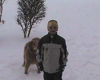 Evan and his dog Brady spend time playing in the snow.