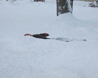This "snow angel" is Andrew Soich. He had just finished shoveling the snow in the driveway at his home in Poland. Photo taken by his mom, Dianne Phillips.