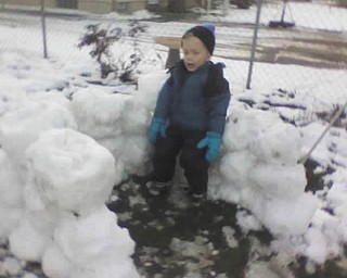 Timmy, 4, of Poland takes a break while building a snow fort. Photo submitted by Gary Kerr.