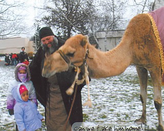 London Rose Rivera, 3, front, and Nevaeh Rivera, 4, check out the camel at the "Journey to Bethlehem" event at Disciple Christian Church. Photo submitted by their grandmother, Aida Morales.