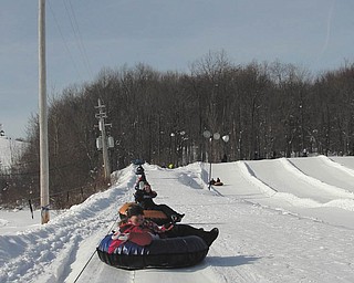 Now that is totally tubular! Samantha and Lindsay Cave from Girard ride their snow tubes on the hill at Alpine Valley Ski Resort in Chesterland, Ohio. Photo sent in by Michele Liggett of Lowellville.