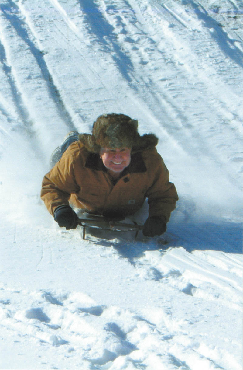 John Grantonic of Poland, who says he is still having fun at 81, sled rides with his grandkids at Mohawk Trails Golf Course in Bessemer, Pa.