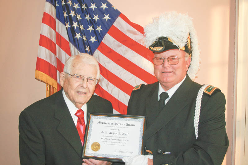 Leland E. Clegg, left, received a 60-year service pin and certificate when Knights Templar honored him for his long dedicated service to Masonry. Dale Hawkins, eminent commander of St. John’s No. 20, Knights Templar Commandery of Youngstown, presented the award at a recent banquet for the York Rite Bodies of Masonry.