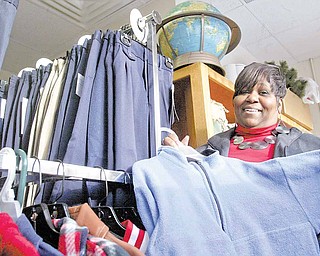 Linda Hoey, parent liaison for the Youngstown schools’ Parent Pathways program, sorts through donated clothing that the program collects for students. The program aims to help families with school-related issues.
