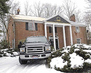 Workers from Nick Hornbeck Construction work on roof of a house on Brook Park Drive in Canfield on Feb. 2, 2011.