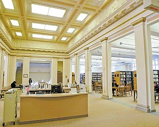 Main Library patrons look through stacks and read at a study area inside the facility. An architectural study recommends $11 million worth of improvements to the library.