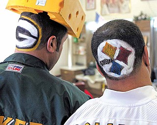 Green Bay Packer fan Mike Coconate,l eft, of Ahwatukee Foothills, and his brother-in-law Pittsburg Steeler fan Howard Davis, right, of Mesa, show off their teams shaved into their hair at Papa Joe's Barbershop in Chandler, Ariz., Friday, Feb. 4, 2011. The Packers and Steelers will face each other in the NFL's Super Bowl XLV football game Sunday, Feb. 6 at Cowboys Stadium in Arlington, Texas.