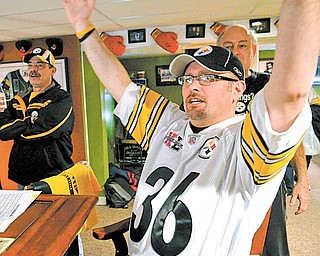 Steelers fans celebrate in the basement of Jim Davis of Austintown while watching the Steelers score a touchdown in Super Bowl XLV.