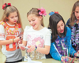 Abigail Sudano, 11, of Berlin Center (second from left) opens a card from a friend at her birthday party at the Salem Community Center Saturday evening. She gets some help from friends Katie Henderson, 10, of Berlin Center, Sudano, Angela Fusillo, 10, of North Jackson and Kendall Dye, 11, of Berlin Center. Sudano asked for donations instead of birthday gifts so she can help local causes.