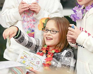 Sara Sudano, 10, of Berlin Center, opens a card from a friend at her birthday party at the Salem Community Center Saturday evening. Sara, along with sister Abigail, 11, asked for donations instead of birthday gifts so they can help local causes.