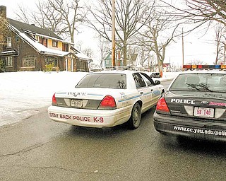 YSU police and Youngstown Police watch over the scene at Indiana Ave - Authorities in northeast Ohio say a shooting at a fraternity house just north of the Youngstown State University campus killed one student and injured 11 people, including six students.