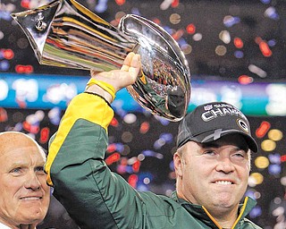 Green Bay Packers head coach Mike McCarthy holds the Vince Lombardi Trophy after the Packers' 31-25 win over the Pittsburgh Steelers in the NFL Super Bowl XLV football game Sunday, Feb. 6, 2011, in Arlington, Texas.