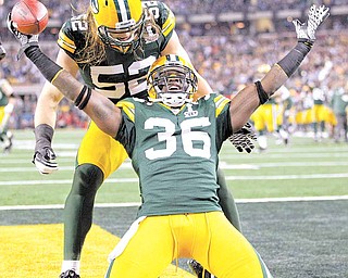 Green Bay Packers' Nick Collins (36) celebrates with teammate Clay Matthews (52) after returning an interception for a touchdown during the first quarter of the NFL football Super Bowl XLV game against the Pittsburgh Steelers Sunday, Feb. 6, 2011, in Arlington, Texas.