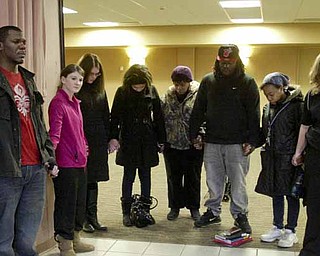 YSU students and faculty joined hands during a Monday prayer service on campus for victims of a weekend shooting.