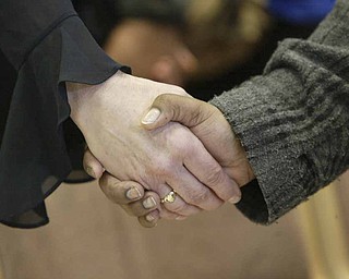 YSU students and faculty joined hands during a Monday prayer service on campus for victims of a weekend shooting.