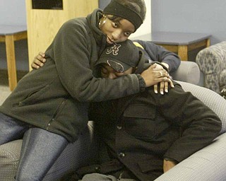 Tyler Thompson, one of the Youngstown State University students who was shot at a weekend party, gets a hug from fellow student Eve Griffins. Thompson wasn’t listed among the original list of those injured because he says he didn’t realize he’d been shot and sought medical attention on his own.