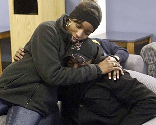 Tyler Thompson, one of the Youngstown State University students who was shot at a weekend party, gets a hug from fellow student Eve Griffins. Thompson wasn’t listed among the original list of those injured because he says he didn’t realize he’d been shot and sought medical attention on his own.