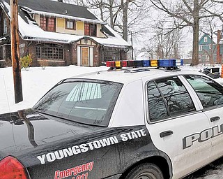 A Youngstown State Police University officer patrols the street near the location of an early morning shooting at a fraternity house just north of the Youngstown State University campus that left student Jamail E. Johnson, 25 of Youngstown dead and 11 injured Sunday, Feb. 6, 2011 in Youngstown, Ohio.