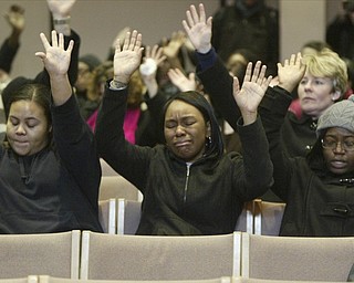 William D. Lewis the vindicator YSU students l-r Jeanna Denson Dana Thomas and Dessera McClendon during a Monday prayer service on campus and after a weekend shooting left one YSU student dead.