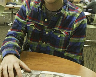 William D. Lewis the vindicator YSU student Ralph Rich looks at a copy of YSU student newspaper while talking about a shooting during an off campus party. Pixed on campus Monday 2-7-11