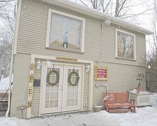 Canfield Wood Folk Designs and Home Decor opened at 79 N. Broad Street about two weeks ago. David Walker, who opened the store with long-term girlfriend Susan Morgione, said he hand-carves many of the items, including the wooden window treatments shown in the store’s second-floor windows.