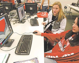 Senior Toni Topoleski and freshman Anna Lugono work on the color design of the T shirt the Intro to Business class will sell this year.