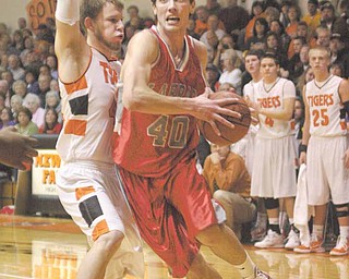 BOYS BBALL - Jacob Jaros (40) drives to the hoop as Brian Moser (44) plays tight defense during their game Tuesday evening.