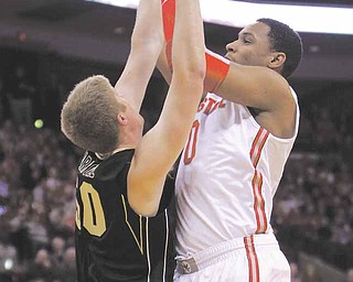 Ohio State's Jared Sullinger, right, shoots over Purdue's Travis Carroll during the first half of an NCAA college basketball game Tuesday, Jan. 25, 2011, in Columbus, Ohio.