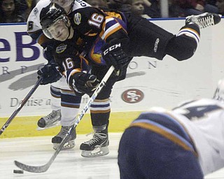 Ryan Belonger makes a one legged shot past Jordan Young of Indiana Wed morning at the Covelli Center. The Phantoms took on the Indiana Ice in a 10 am game with school children from the area attending.
