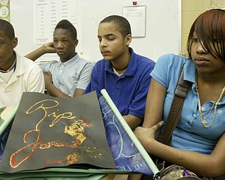 Woodrow Wilson Middle School eighth graders, from left, Allen Torres, Ramses Terry, Charles Dorsett Jr. and Jo’Nell Jackson, talk about Jamail Johnson, a Youngstown State University student killed in a weekend shooting. Johnson worked as a math tutor at the school and students wrote letters, created cards and made posters in his memory.