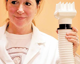 Sarah Casello-Rees is the owner of The Lice Brigade and boutique in Ann Arbor, Michigan, which specializing in treating lice called Rapunzel's Lice. She holds the LouseBuster device that helps treat lice on Wednesday, January 19, 2011.