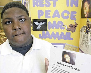 Jerrell Shorter, an eighth-grader at Woodrow Wilson Middle School, shows a letter he wrote to the late Jamail Johnson, the YSU student who died in Sunday’s shootings.