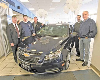 Debby Blalock of Canfield won a two-year lease on this new Chevrolet Cruze donated by Greenwood Chevrolet in Austintown, an incentive for the 2010 fundraising campaign for United Way of Youngstown and the Mahoning Valley. The United Way exceeded its $2.5 million goal. Surrounding the grand prize are, from left, Bill Padisak, chairman of the UW’s trustee board; David Green, president of United Auto Workers Local 1714, Lordstown, where the Cruze is made; Bob Parcell, General Motors Lordstown plant manager; Bill Piechocki, GM personnel director; and Jim Graham, president of UAW Local 1112.