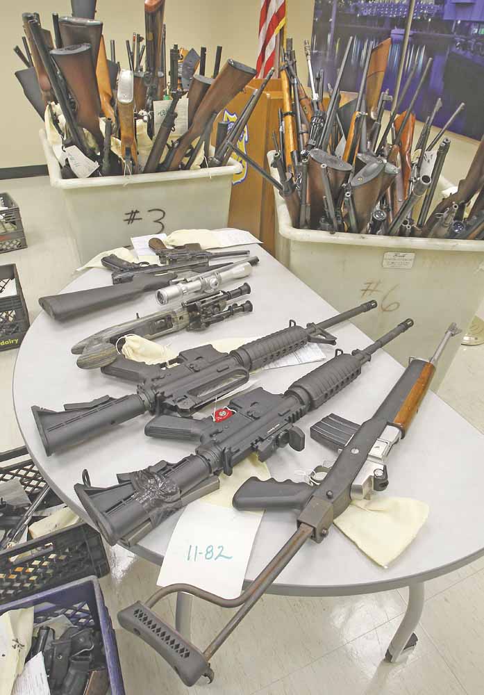 The 232 weapons in three large rolling bins and four milk crates were on display at the Cleveland Police headquarters confiscated from Abbot John Henry of St. Herman's House of Hospitality in Cleveland February 8, 2011.  Investigators with Henry's consent  rounded up 80 guns with ammunition from a home near St. Herman's. On Friday, another 150 guns and ammunition were recovered from a Trumbull County farm the shelter owns.  
