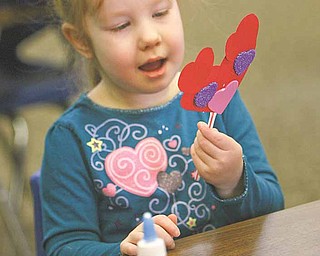 Molly Durkin, 4, works on her Valentine mouse after Valentine storytime at the Girard Free Library Wednesday.