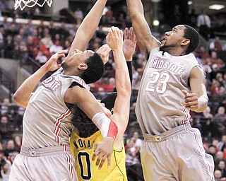 Ohio State's Jared Sullinger, left, and David Lighty go up for a rebound over Michigan's Zack Novak during the second half of an NCAA college basketball game in Columbus, Ohio, Thursday, Feb. 3, 2011. Ohio State won 62-53. (AP Photo/Paul Vernon)