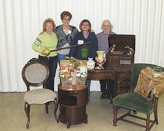 From left, Junior Group of Goodwill volunteers Patty Suchora, Kathy Gerberry, Sue Miller and Shirley Rodgers display items to be auctioned off during the 19th annual Junior Group of Goodwill Antique and Collectibles auction on March 5. The two-day event begins with a gala on March 4, which includes a jewelry sale, live auction of new items a basket raffle, silent auction and a basket auction.